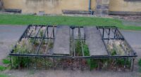 An iron cage, called a mortsafe, enclosing a grave in Greyfriars Kirkyard, Edinburgh.