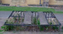 An iron cage, called a mortsafe, enclosing a grave in Greyfriars Kirkyard, Edinburgh.