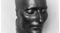 Bronze cast of the death mask of Napoleon I, face only, eyes closed.